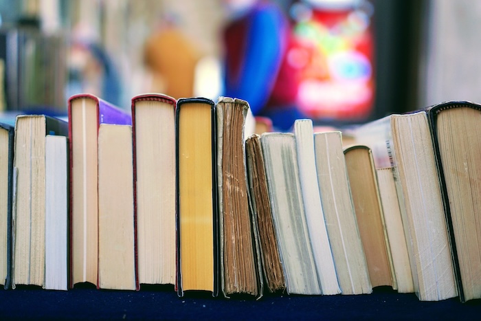 Collection of books stacked horizontally.