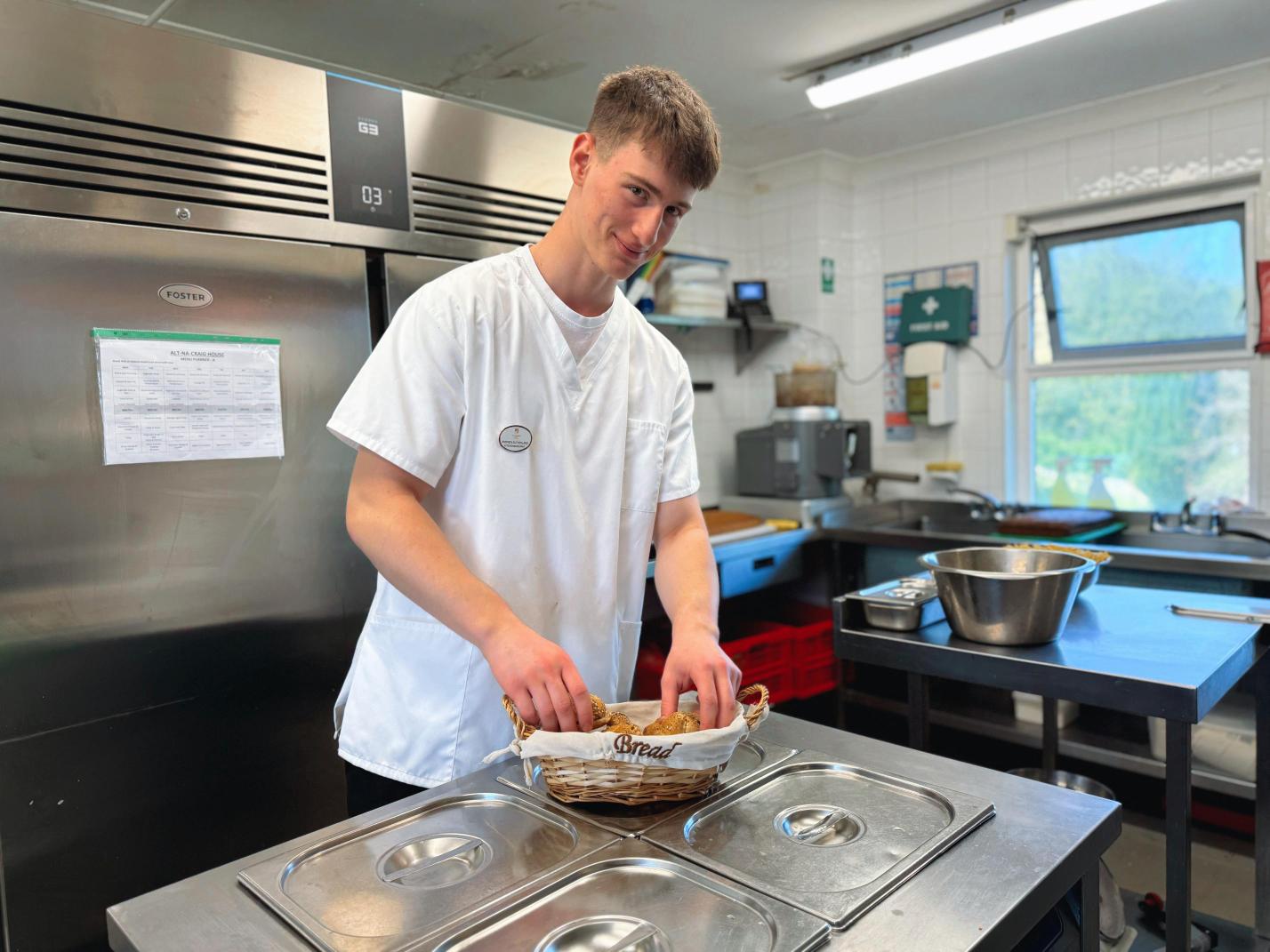 Chef busy preparing a bread basket in a kitchen.